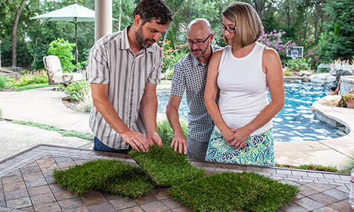 homeowners purchasing artificial grass for install