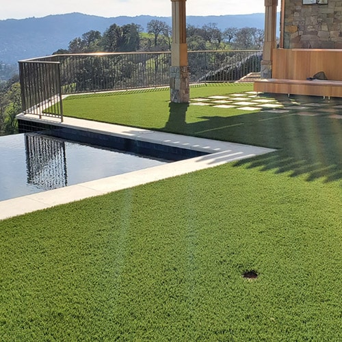 realistic artificial grass installed by a pool